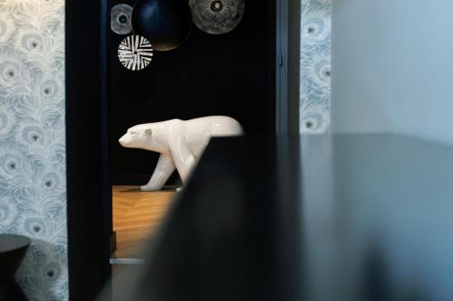 a white horse statue sitting on the floor in a room at Maison Tillot in Dijon