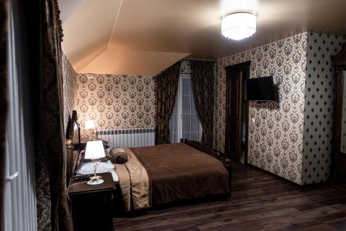 a bedroom with a bed and a lamp on a table at Едем in Brzezhany