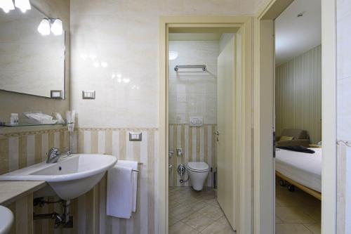 a bathroom with a sink and a shower and a toilet at Domus Australia in Rome