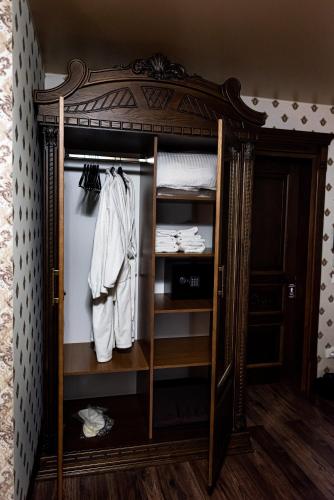 a wardrobe with a mirror in a room at Едем in Brzezhany