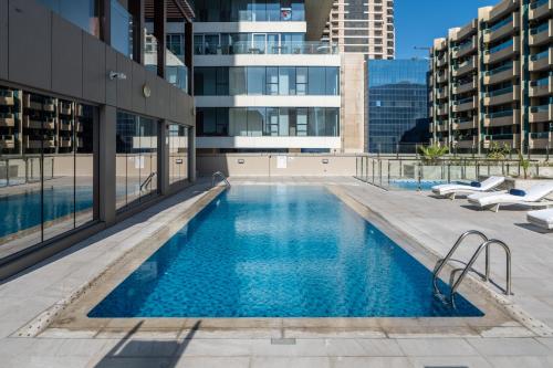 a swimming pool on the side of a building at SUHA Mina Rashid Hotel Apartments in Dubai