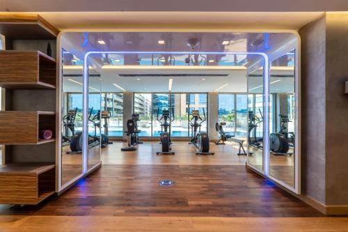 a gym with treadmills and ellipticals in a building at SUHA Mina Rashid Hotel Apartments in Dubai