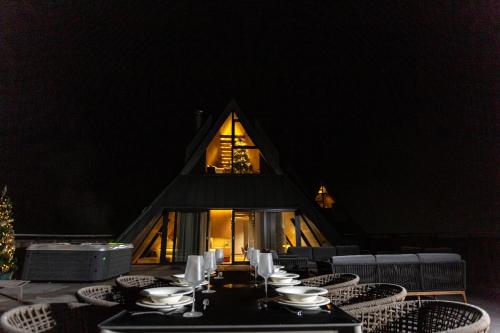 a table with bowls and plates on top of it at Hotel Monti Spa & Wellness in Igman