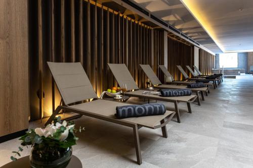 a row of tables and chairs in a room at Hotel Monti Spa & Wellness in Igman