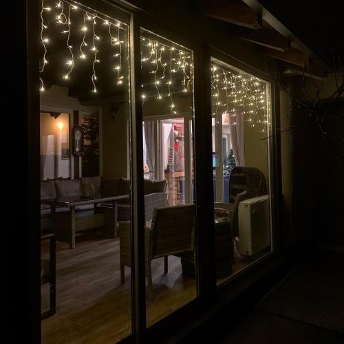 a living room with christmas lights in the window at Vila Impresija, Fruška gora in Novi Sad