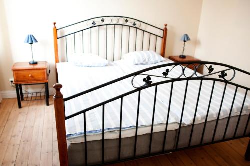 a bedroom with a bed and a table with a night stand at Reftele Wardshus in Reftele