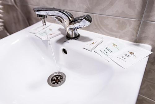 a bathroom sink with a chrome faucet at Едем in Brzezhany
