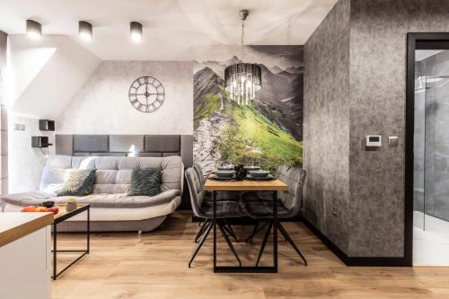 a living room with a couch and a table at Tatra Resort & SPA in Kościelisko