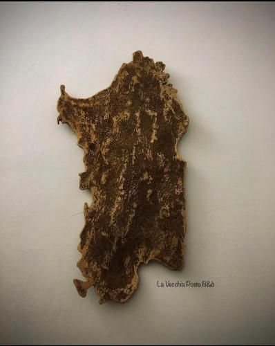 a piece of metal that looks like a map of nigeria at La Vecchia Posta B&B in Calangianus