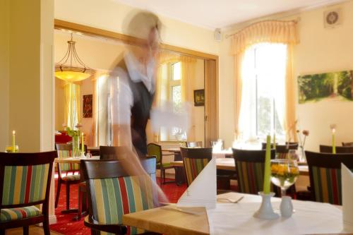 a person is jumping in the air over a table at Land-gut-Hotel Allerhof in Frankenfeld