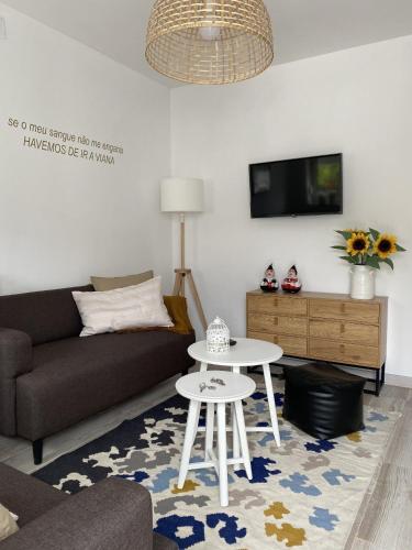a living room with a couch and a table at Guest House AltoNível in Viana do Castelo