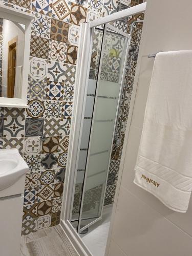 a bathroom with a shower with a glass door at Guest House AltoNível in Viana do Castelo