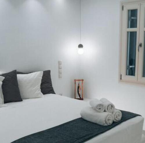 a bedroom with a bed with a towel on it at MarKaMar in Loutraki