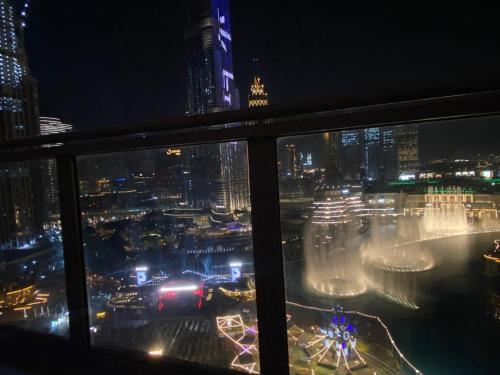 a view of a city at night from a window at Downtown Al Bahar Apartments in Dubai