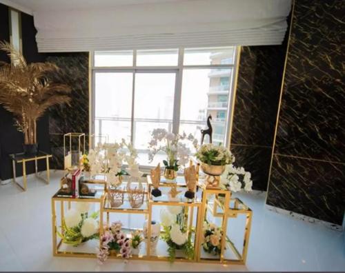 a room filled with lots of plants and flowers at Downtown Al Bahar Apartments in Dubai