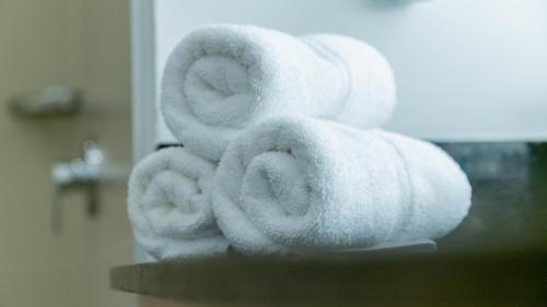 a pile of white towels stacked on a counter at Holiday Inn Express Managua, an IHG Hotel in Managua