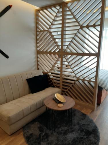 a living room with a couch and a table at PRESIDENT KOP A-1 in Kopaonik
