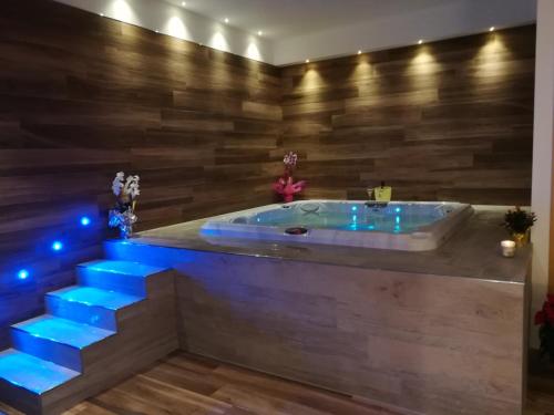 a jacuzzi tub in a room with blue lights at Il Roccolo Di Valcerasa in Treia