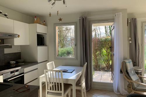 a kitchen with a table and chairs and a window at #P0 Le Montbonnot Luminous T2 Garden - Terrace in Montbonnot-Saint-Martin