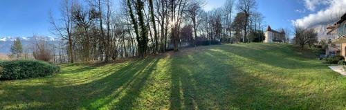 a large grassy yard with a house and trees at #P0 Le Montbonnot Luminous T2 Garden - Terrace in Montbonnot-Saint-Martin
