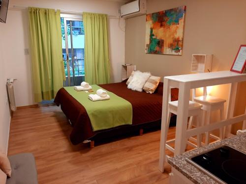 a bedroom with a bed with towels on it at Cono de Arita in Salta