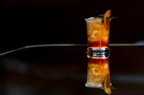 a drink with an orange slice in a glass at Hotel AKA Boston Common in Boston