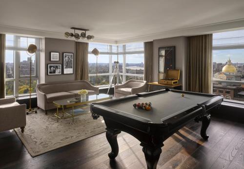 a large living room with a pool table in the middle at Hotel AKA Boston Common in Boston