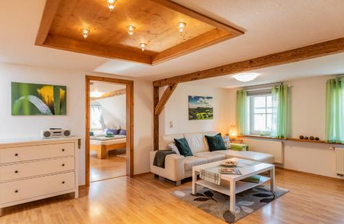 a living room with a couch and a table at Im alten Rathaus in Bad Liebenstein