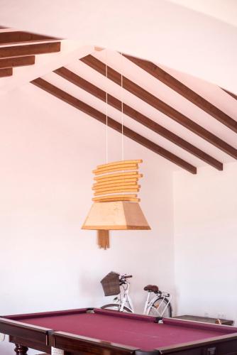 a ping pong table in a room with a ceiling at Monte do Giestal - Casas de Campo & Spa in Abela