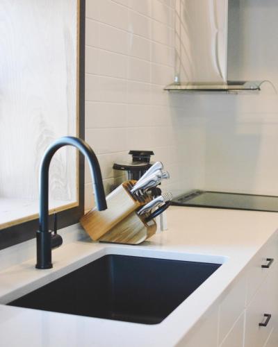 a kitchen counter with a sink and a knife holder at The Flying Steamshovel Inn in Rossland