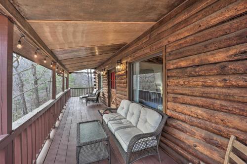 a porch with a couch on the back of a house at Relaxing Retreat with Private Dock on Claytor Lake! in Dublin