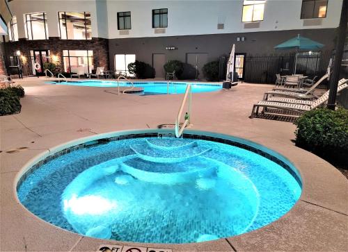 a large blue swimming pool in the middle of a building at Holiday Inn Express & Suites St George North - Zion by IHG in Washington