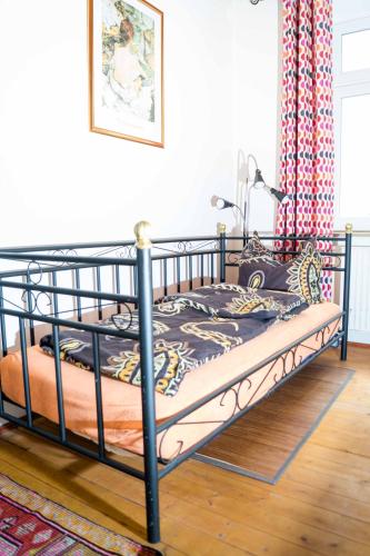 a bed in a room with a black frame at Altstadt Charme in Augsburg