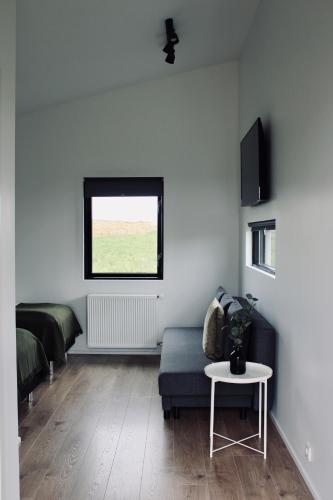 a living room with a couch and a window at iStay Cottages in Sandgerði