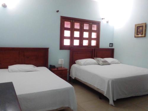 Ein Bett oder Betten in einem Zimmer der Unterkunft Hotel Aluge