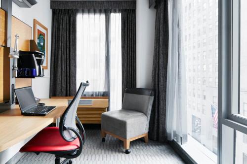 an office with a desk and a chair next to a window at The Jewel Hotel, New York in New York