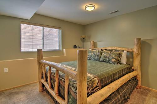 a bedroom with a wooden bed in a room at Hilltop Haven in Florissant Deck and Mountain View! in Florissant