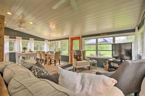 a living room with a couch and a television and a table at Georgetown Escape with Slip Boat Access Only in Georgetown