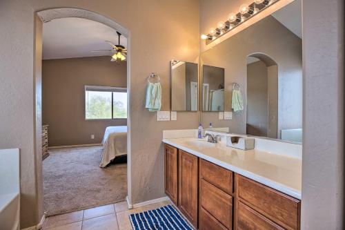 a bathroom with a sink and a large mirror at Maricopa Home with Outdoor Seating, 2 Mi to Golf! in Maricopa