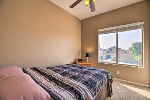 a bedroom with a bed and a large window at Maricopa Home with Outdoor Seating, 2 Mi to Golf! in Maricopa