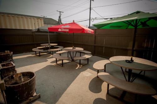 a group of tables and umbrellas on a patio at River Inn in Nipawin