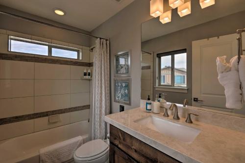 a bathroom with a sink and a toilet and a mirror at Modern Huntsville Resort Retreat with Deck and Hot Tub in Huntsville