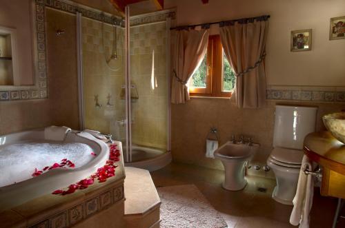 uma casa de banho com uma banheira, um WC e um chuveiro em Bungalows Buena Vista em San Carlos de Bariloche