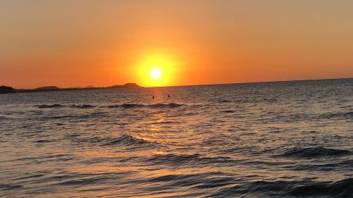 a sunset over the ocean with the sun setting at Villa Yalirocu in Carretal