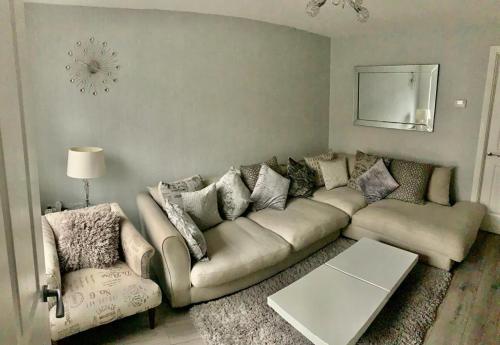 a living room with a couch and two chairs at Kay's Place - Modern 3 Bed in Manchester
