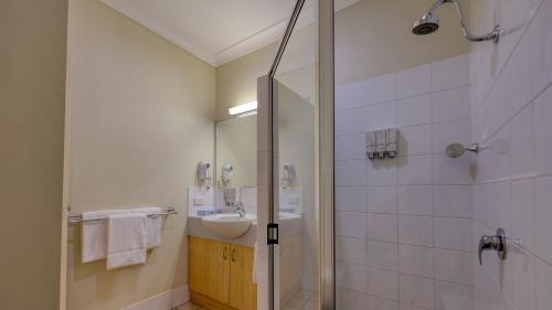 a bathroom with a sink and a shower at Country Roads Motor Inn in Goondiwindi