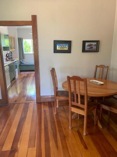 a kitchen and dining room with a table and chairs at One Panama in Martinborough 