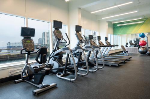 a gym with rows of exercise bikes and tread machines at Holiday Inn Kingston - Waterfront by IHG in Kingston