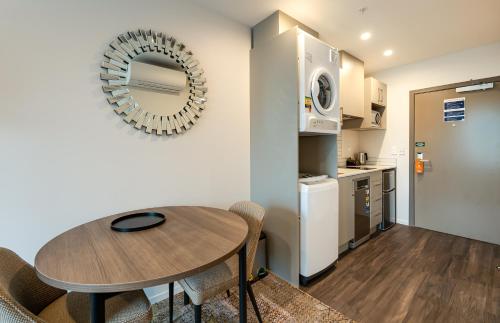 a kitchen and dining room with a table and a mirror at La Quinta by Wyndham Remarkables Park Queenstown in Queenstown