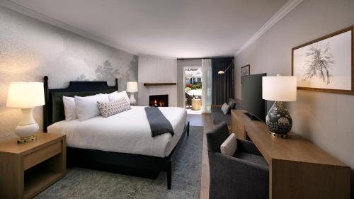 ein Schlafzimmer mit einem Bett und ein Wohnzimmer in der Unterkunft Fireside Inn on Moonstone Beach in Cambria
